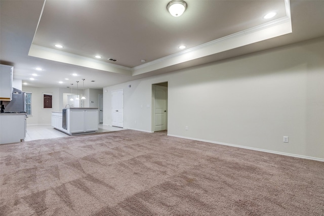 7793 Gulf Walk Rd, Frisco, TX 75036 - unfurnished living room featuring crown molding, a raised ceiling, light colored carpet, recessed lighting, and baseboards
