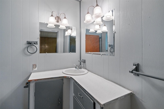 bathroom featuring a notable chandelier and vanity