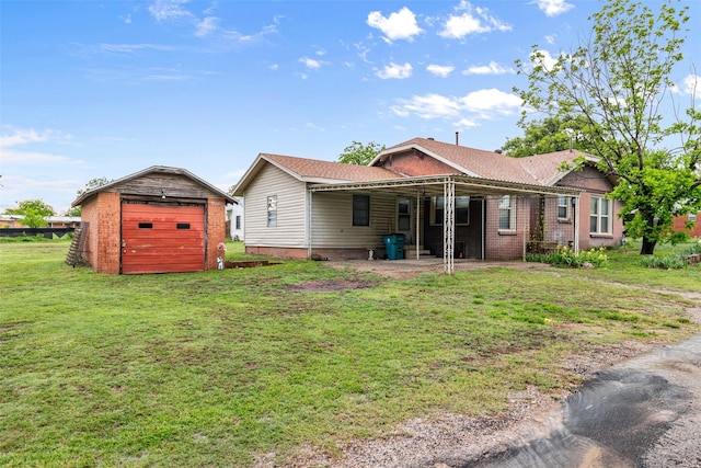 rear view of house with a garage, an outbuilding, and a lawn