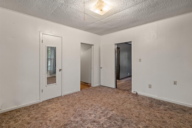 spare room with carpet flooring and a textured ceiling
