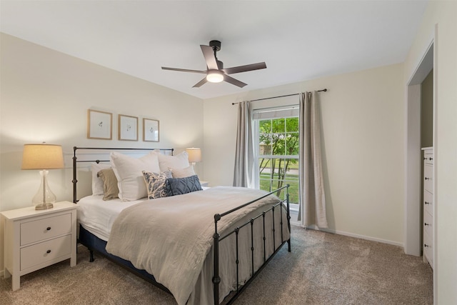 carpeted bedroom with baseboards and a ceiling fan