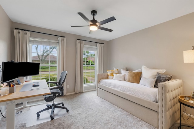 carpeted bedroom with baseboards and ceiling fan