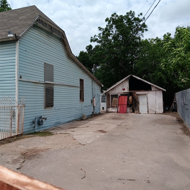 view of property exterior with an outbuilding and a storage unit