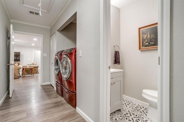 3707 Knob Hill Rd, Azle, TX 76020 - washroom featuring washing machine and clothes dryer, attic access, crown molding, baseboards, and light wood finished floors
