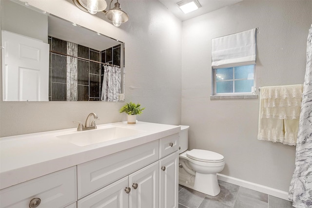 full bathroom with toilet, baseboards, tiled shower, and vanity