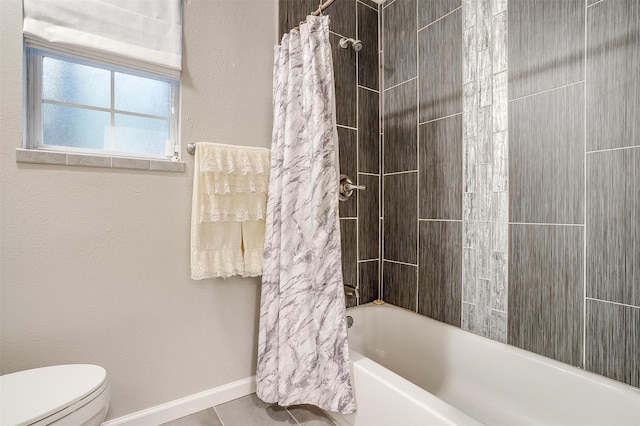 bathroom featuring toilet, baseboards, and shower / bathtub combination with curtain