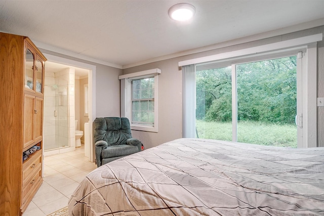 bedroom with light tile patterned floors and ensuite bathroom