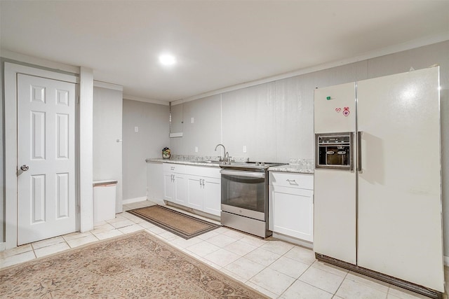 kitchen with electric range, crown molding, white refrigerator with ice dispenser, light tile patterned floors, and white cabinets