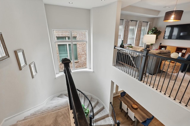 stairs with baseboards and wood finished floors