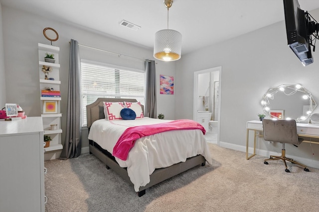 bedroom with baseboards, visible vents, ensuite bathroom, and carpet