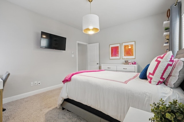 carpeted bedroom featuring baseboards