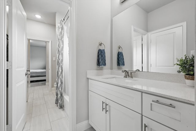 bathroom with vanity, baseboards, recessed lighting, and tile patterned flooring