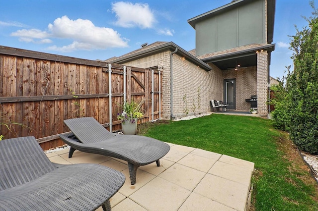 view of patio with a fenced backyard and area for grilling