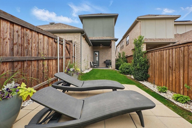 view of patio featuring a fenced backyard and a grill
