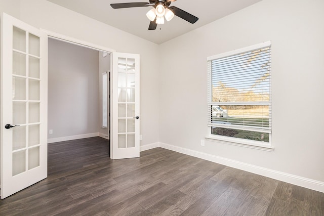 empty room with french doors, baseboards, ceiling fan, and dark wood-style floors