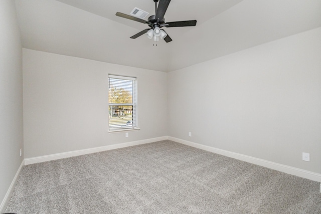carpeted spare room with visible vents, a ceiling fan, baseboards, and lofted ceiling