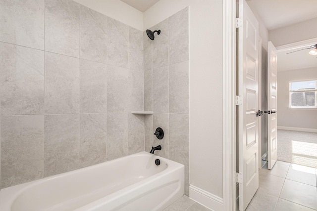 bathroom featuring baseboards, shower / bathing tub combination, and tile patterned flooring