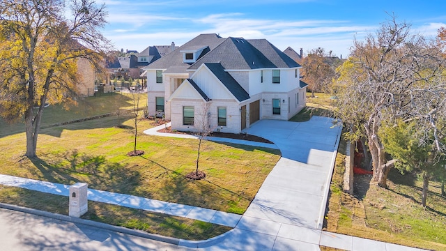 traditional home featuring fence, a shingled roof, stone siding, a garage, and driveway
