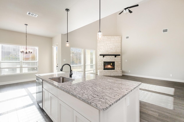 kitchen featuring baseboards, visible vents, and a sink