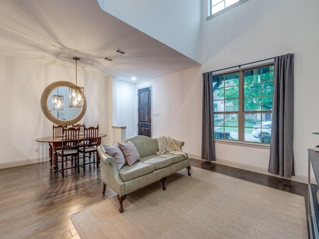 6285 Davison Way, Mckinney, TX 75070 - living area with baseboards, visible vents, wood finished floors, and a notable chandelier