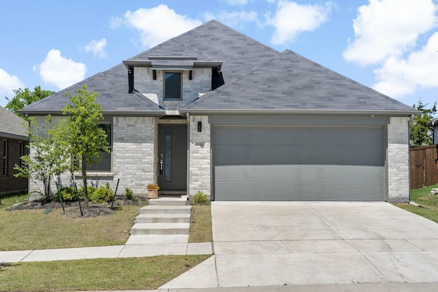 view of front of house featuring fence, driveway, a shingled roof, and a garage