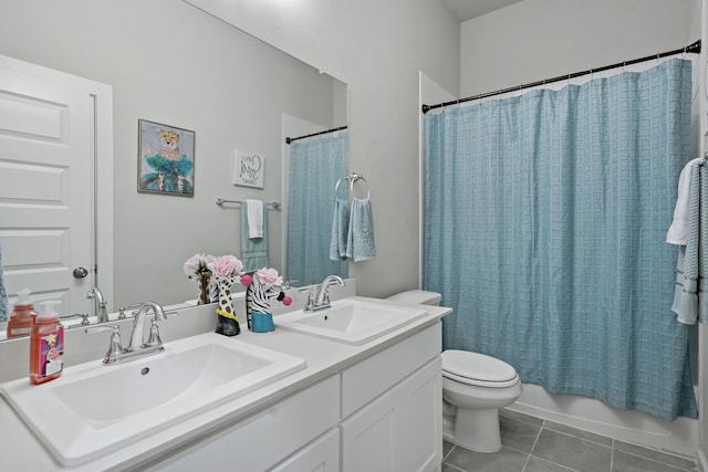 full bath featuring a sink, tile patterned floors, toilet, and shower / bath combination with curtain