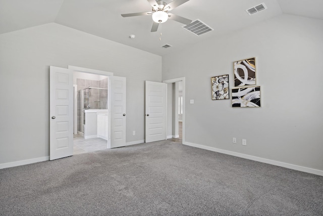 unfurnished bedroom featuring visible vents, lofted ceiling, and carpet