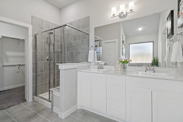 bathroom with tile patterned floors, a sink, and a stall shower