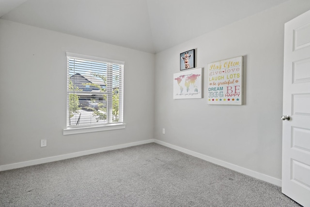 unfurnished room with baseboards, carpet flooring, and lofted ceiling