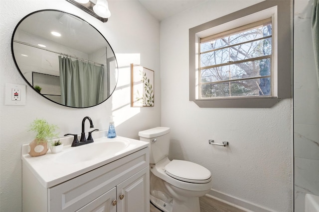 full bath featuring vanity, wood finished floors, toilet, baseboards, and a shower with curtain
