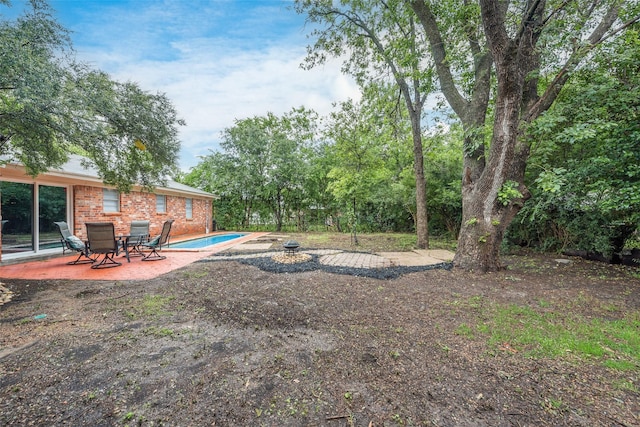 view of yard with an outdoor pool and a patio area