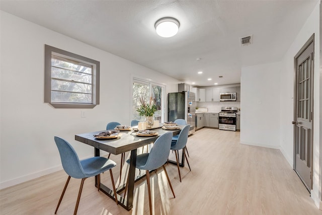 dining space featuring baseboards, recessed lighting, light wood-style flooring, and visible vents
