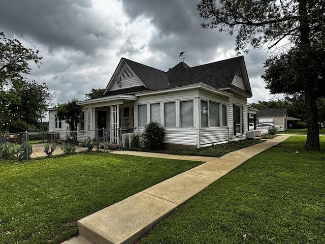 322 Hill St, Grand Prairie, TX 75050 - view of front of home with fence, roof with shingles, and a front yard