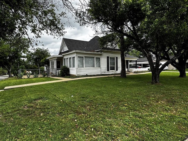 322 Hill St, Grand Prairie, TX 75050 - view of side of property featuring a lawn, fence, and a shingled roof