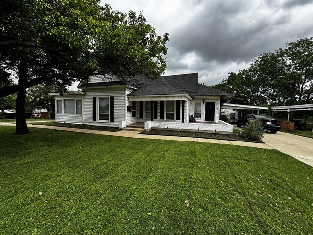 322 Hill St, Grand Prairie, TX 75050 - view of front of property with driveway, a shingled roof, and a front lawn