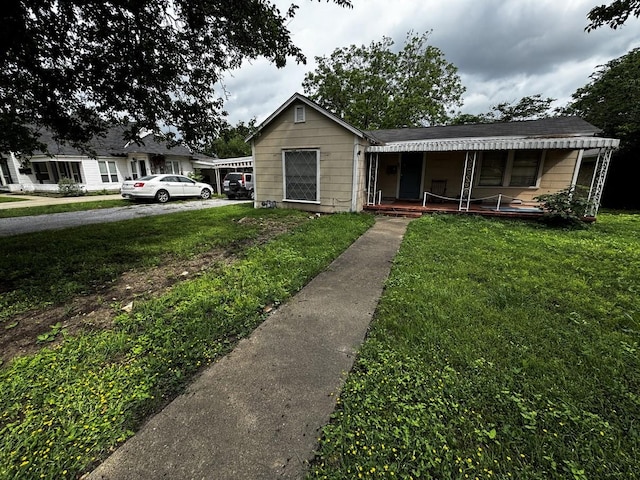 322 Hill St, Grand Prairie, TX 75050 - view of front of property featuring a front lawn and covered porch