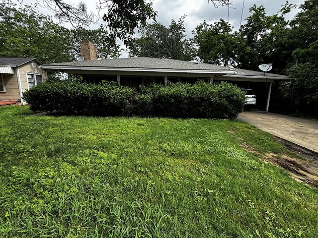 322 Hill St, Grand Prairie, TX 75050 - view of front facade with a carport, a chimney, driveway, and a front lawn