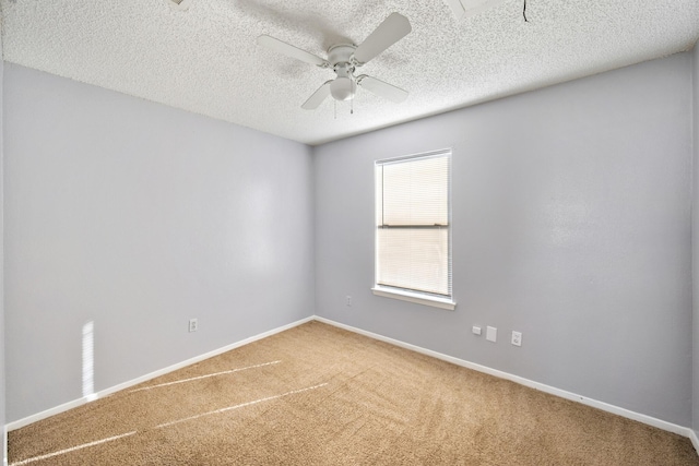 spare room with baseboards, ceiling fan, carpet, and a textured ceiling