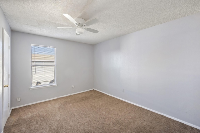 carpeted empty room with a textured ceiling, ceiling fan, and baseboards