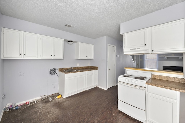 kitchen with a textured ceiling, white range with electric cooktop, dark wood finished floors, under cabinet range hood, and white cabinetry