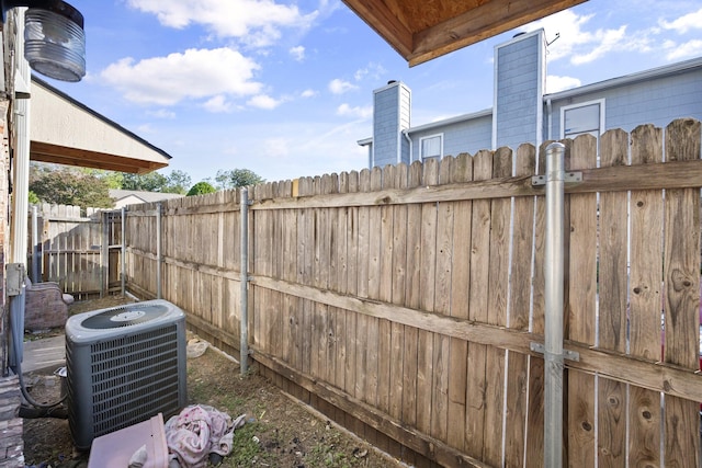 view of yard with fence and cooling unit