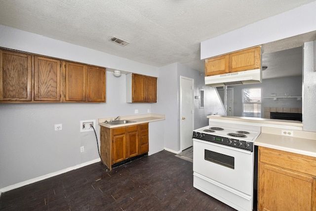 kitchen featuring a sink, brown cabinetry, under cabinet range hood, visible vents, and white electric stove