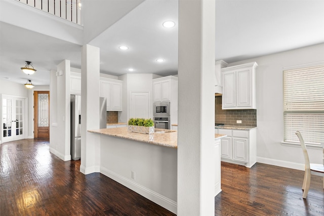 1005 Middleton St, Forney, TX 75126 - kitchen featuring stainless steel appliances, decorative backsplash, white cabinets, dark wood-type flooring, and recessed lighting