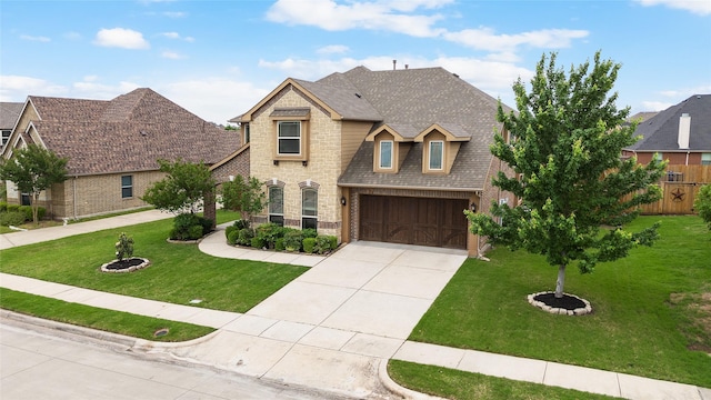 1005 Middleton St, Forney, TX 75126 - view of front facade with brick siding, a garage, concrete driveway, a front yard, and roof with shingles