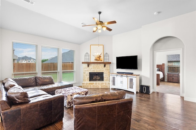 living room with a fireplace, ceiling fan, lofted ceiling, and dark wood-type flooring