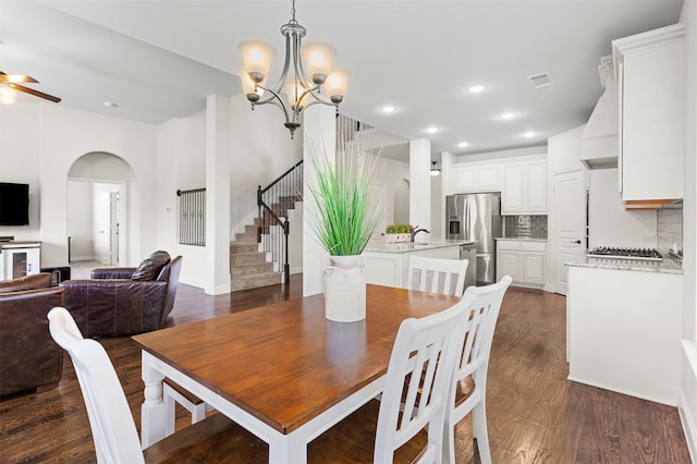 1005 Middleton St, Forney, TX 75126 - dining room with stairway, arched walkways, ceiling fan, dark wood-style floors, and a chandelier