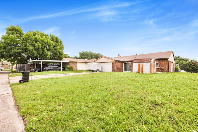 exterior space featuring brick siding, a garage, driveway, and a front lawn