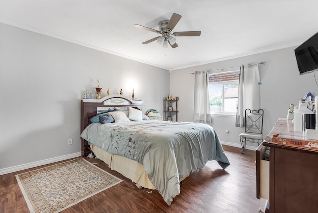 bedroom featuring baseboards, ornamental molding, dark wood finished floors, and ceiling fan