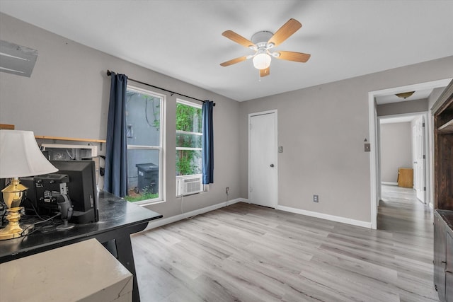 unfurnished office featuring baseboards, light wood finished floors, and ceiling fan