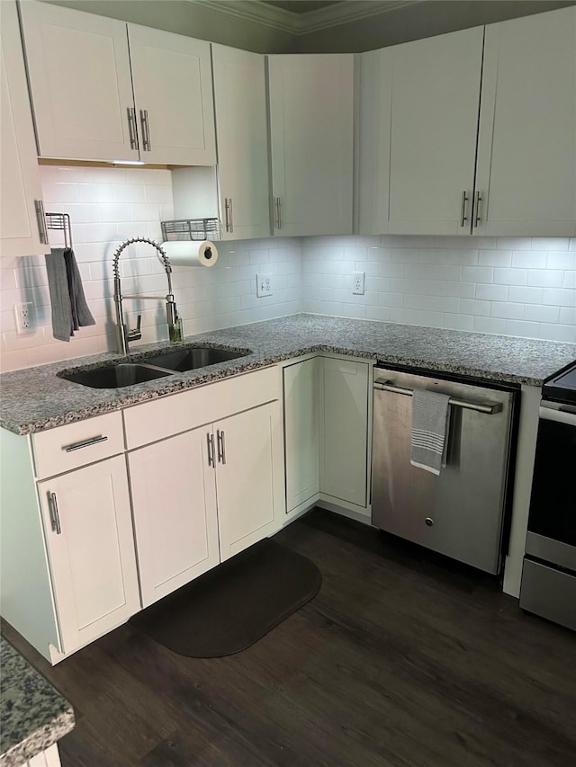 kitchen with a sink, light stone counters, stainless steel appliances, and dark wood-style flooring